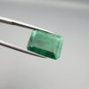 Multi-angle macro photographs of a 6.34-carat natural emerald (Panna / Zamrud) from the Swat Valley in Pakistan held in metal tweezers, showcasing an emerald cut, a vibrant green body, and characteristic internal crystal inclusions.