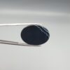 Multi-angle macro photographs of a 26.88-carat natural black banded agate (Sulemani Aqeeq) oval cabochon held in metal tweezers, showcasing a high-gloss obsidian black dome with an intricate, wavy organic white veining pattern across the surface.