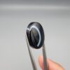 Exceptional 26.53 carat natural black banded agate (Sulemani Aqeeq), expertly finished into a high-gloss oval cabochon displaying a bold, curved concentric white band wrapping seamlessly around an intense jet-black core.