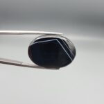 Striking 25.19 carat natural black banded agate (Sulemani Aqeeq) featuring a mirror-polished finish and clean, architecturally precise angular white banding lines contrasting against an intense jet-black body.