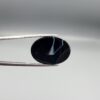 Striking 25.19 carat natural black banded agate (Sulemani Aqeeq) featuring a mirror-polished finish and clean, architecturally precise angular white banding lines contrasting against an intense jet-black body.