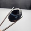 Rare 26.66 carat natural black banded agate (Sulemani Aqeeq) featuring a mirror-polished deep black body traversed by an extraordinary, luminous blue-gray and bright white eye-like arc.
