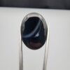 Rare 26.66 carat natural black banded agate (Sulemani Aqeeq) featuring a mirror-polished deep black body traversed by an extraordinary, luminous blue-gray and bright white eye-like arc.