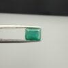 Multi-angle macro photographs of a 1.86-carat natural Zambian emerald (Zamrud) held in metal tweezers, showcasing a classic step-cut emerald octagonal shape, vibrant leafy green hue, and characteristic natural internal inclusions (jardin) across the table.
