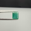 Multi-angle macro photographs of a 1.86-carat natural Zambian emerald (Zamrud) held in metal tweezers, showcasing a classic step-cut emerald octagonal shape, vibrant leafy green hue, and characteristic natural internal inclusions (jardin) across the table.