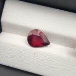 Majestic 3.72 carat natural Madagascan Rhodolite Garnet displaying an elegant pear cut with deep raspberry-red body color, exceptional crystal clarity, and subtle purplish-rose fire.