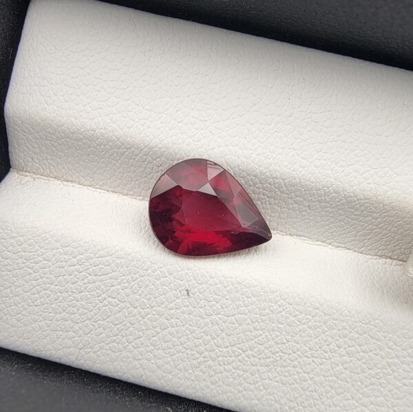 Majestic 3.72 carat natural Madagascan Rhodolite Garnet displaying an elegant pear cut with deep raspberry-red body color, exceptional crystal clarity, and subtle purplish-rose fire.
