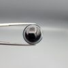 Multi-angle macro photographs of a 14.77-carat natural African Eye Agate (Sulemani Aqeeq) held in gem tweezers, showing a high round cabochon dome with a deep onyx-black core, sharp white outer ringing, tiered side profile bands, and a flat jet-black base with fine white agate pinstripes.