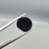 Multi-angle macro photographs of an 8.02-carat natural African Banded Eye Agate (Sulemani Aqeeq) held in steel gem tweezers, displaying a high round cabochon dome with wavy concentric white and earth-brown banding around a deep black core, crisp side fortification layers, and a flat jet-black base.