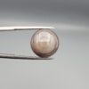 Multi-angle macro photographs of a 10.43-carat natural African Banded Eye Agate (Sulemani Aqeeq) held in gem tweezers, displaying a high round cabochon dome with translucent smoky-white mist halo eye banding, flank-textured fortification rings along the side profile, and a flat translucent base with a bright focal spot center.