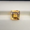 High-resolution macro photographs showing a 4.22-carat natural Citrine Quartz (Sunela) octagon step cut gemstone displayed in a luxury white-padded display box, exhibiting luminous golden-yellow saturation, eye-clean clarity, and crisp step-cut facets.