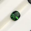 High-resolution scan of an official GGI (Galaxy Gemological Institute) Gemstone Report for a 1.48-carat Natural Chrome Green Tourmaline sourced from Tanzania, detailed with certificate number KHI2610280448, cushion mixed cut dimensions (7.77 x 6.94 x 4.33 mm), transparent green color, and QR verification code.