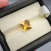 High-resolution macro photographs showing a 4.22-carat natural Citrine Quartz (Sunela) octagon step cut gemstone displayed in a luxury white-padded display box, exhibiting luminous golden-yellow saturation, eye-clean clarity, and crisp step-cut facets.